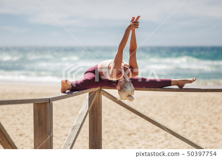 Caucasian blonde woman practicing yoga in the Caucasian blonde woman practicing yoga in the 50397754