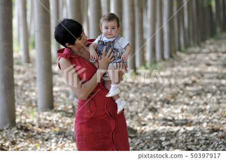 Mother and her little daughter in the forest Mother and her little daughter in the forest 50397917