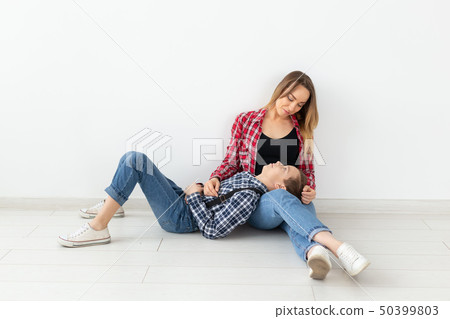 mothers day, children and family concept - cute teen boy with his young mother at home 50399803