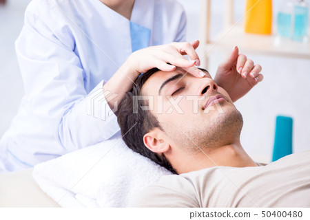 Young handsome man visiting female doctor cosmetologist 50400480