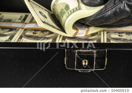 Black case full of dollar bills close up.Money 50400819