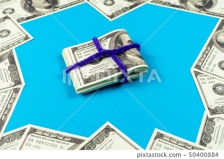 Dollar bills folded in half on light blue Dollar bills folded in half on light blue 50400884