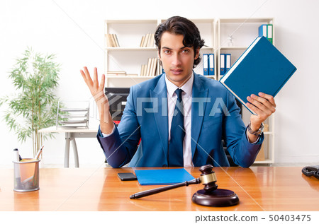 Young handsome judge sitting in courtroom   50403475