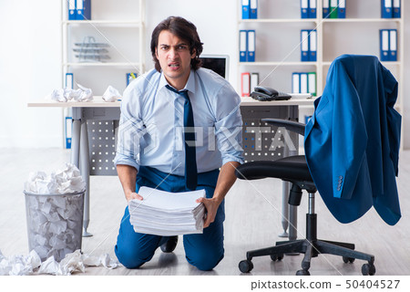 Businessman rejecting new ideas with lots of papers Businessman rejecting new ideas with lots of papers 50404527