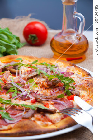 pizza with beef bacon chicken red onion and arugula pizza with beef bacon chicken red onion and arugula 50404795