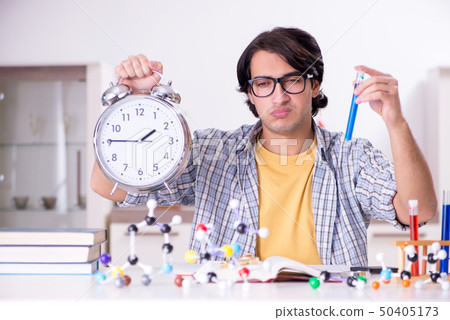 Young student physicist preparing for exam at home     50405173