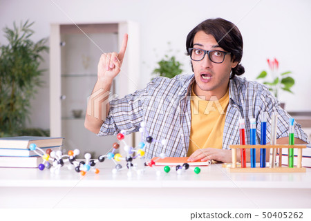 Young student physicist preparing for exam at home Young student physicist preparing for exam at home 50405262