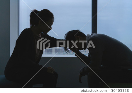 depressed asian man talking with psychologist 50405528