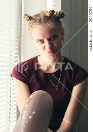 girl making grimace 50407994