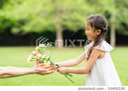Parent and child handing flowers Parent and child handing flowers 50408190
