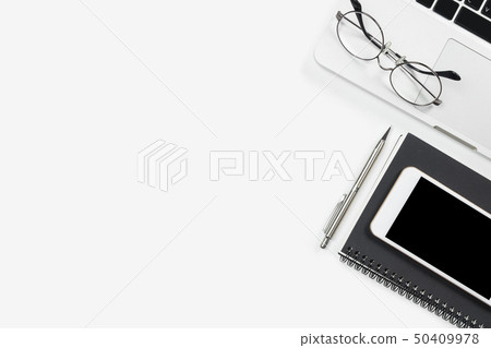 White office desk table with laptop and supplies White office desk table with laptop and supplies 50409978