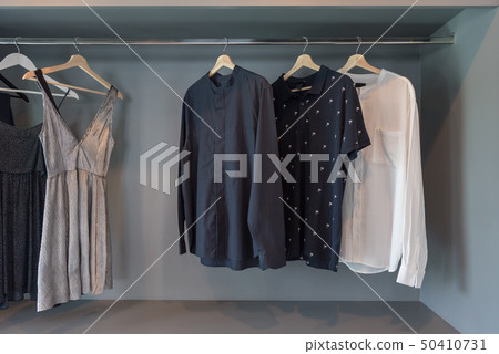 modern closet with clothes hanging 50410731