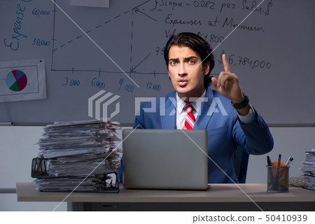 Young elegant financial specialist working in the office night t Young elegant financial specialist working in the office night t 50410939