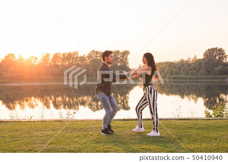 Kizomba, bachata, zouk and latin social dance concept - Man and woman dancing over nature background 50410940