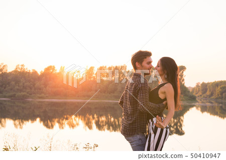 Romantic, social dance and people concept - young couple dancing bachata on the background of sunset Romantic, social dance and people concept - young couple dancing bachata on the background of sunset 50410947