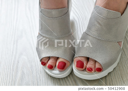 The Womens legs in summer white sandals The Womens legs in summer white sandals 50412908