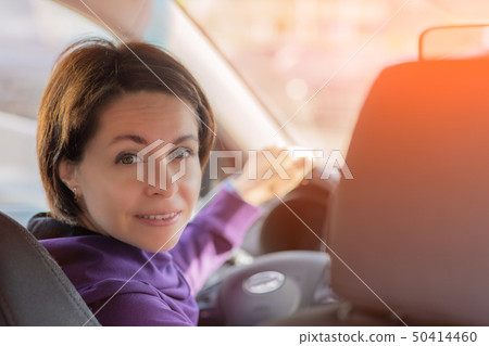 Young Female Driving Car on Highway in Country During summer. Backseat View Young Female Driving Car on Highway in Country During summer. Backseat View 50414460