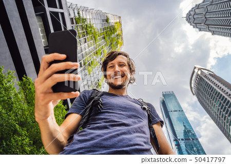 man using map app on smartphone on the background of skyscrapers man using map app on smartphone on the background of skyscrapers 50417797