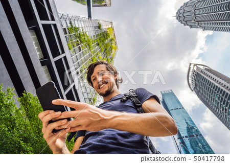 man using map app on smartphone on the background of skyscrapers man using map app on smartphone on the background of skyscrapers 50417798