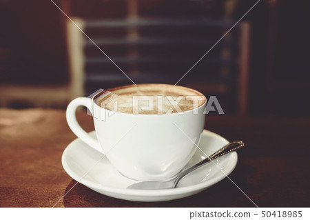 Hands of man holding entwine cup of coffee 50418985