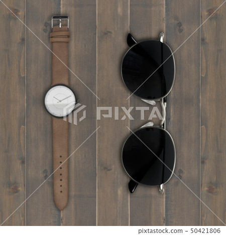 sunglasses and wristwatch on wooden background 50421806