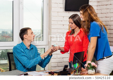 Office staff share the money at the table 50425110