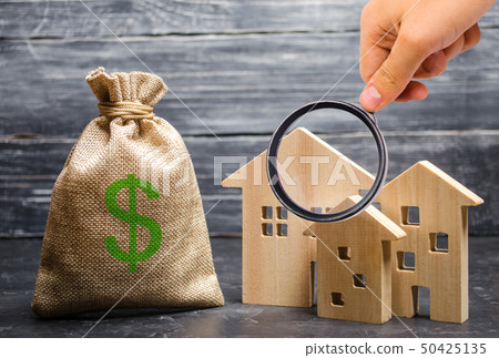 Magnifying glass is looking at the three houses 50425135