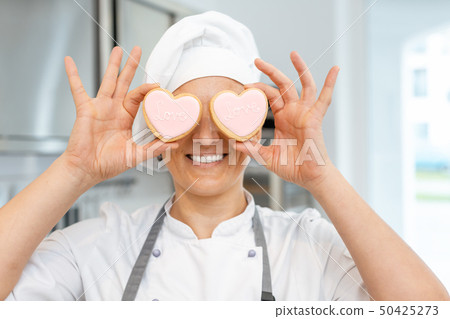 Confectioner with heart shaped cookies 50425273