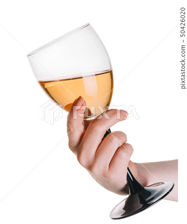glass of white wine in a female hand 50426020