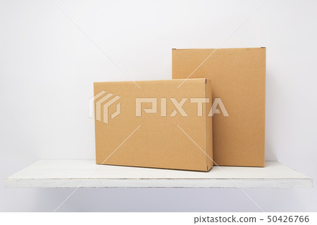 cardboard box on wooden shelf cardboard box on wooden shelf 50426766