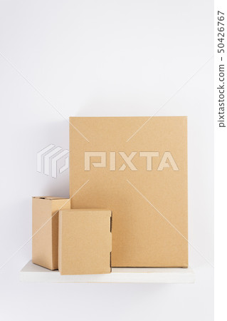 cardboard box on wooden shelf 50426767