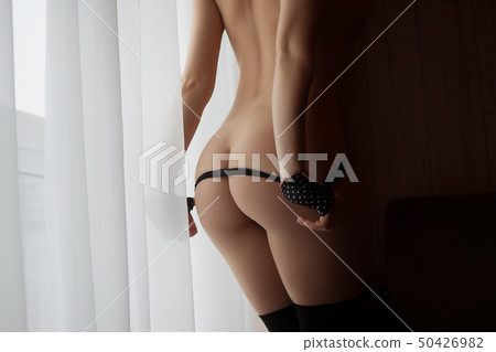 Woman with perfect body removing underwear 50426982