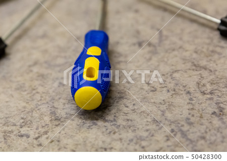 plastic pen blue yellow iron screwdriver close-up 50428300