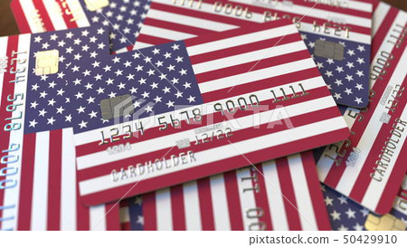 Pile of credit cards with flag of the United States. American banking system conceptual 3D rendering 50429910