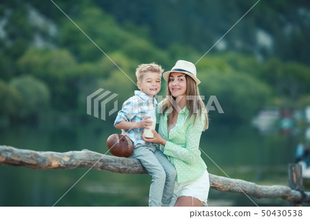 Mother and child together in a meadow playing and having fun 50430538