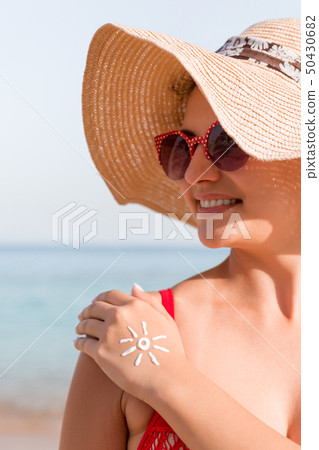 Young woman with sun shape on her hand made of Young woman with sun shape on her hand made of 50430682