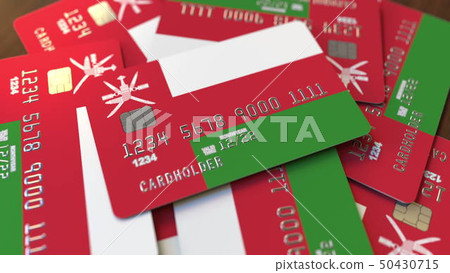 Pile of credit cards with flag of Oman. Omani banking system conceptual 3D rendering Pile of credit cards with flag of Oman. Omani banking system conceptual 3D rendering 50430715
