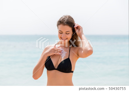 Young attractive woman is protecting her skin on Young attractive woman is protecting her skin on 50430755