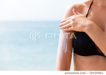 Beautiful lady is sunbathing on the beach 50430861
