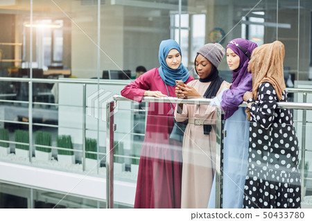 Couple young business muslim female using smart phone contact with partner Couple young business muslim female using smart phone contact with partner 50433780