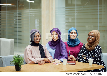 Multiracial group of muslim women dressed in national clothes posing in group 50434029
