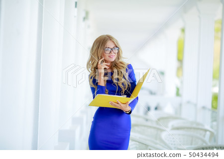 Business Lady with a yellow folder and phone. 50434494