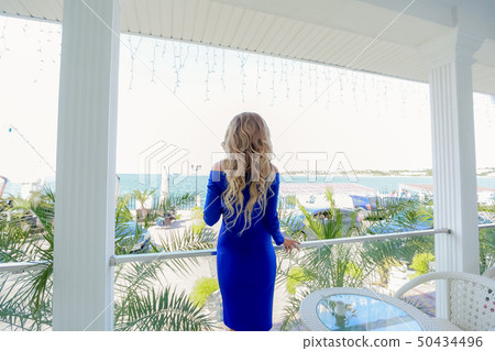 The girl in the blue dress on the balcony vacation. 50434496