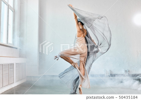 Female ballet dancer with white flowing fabric. Flow shapes and movement. 50435184