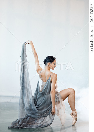Beautiful young woman dancing in studio in pointe shoes Beautiful young woman dancing in studio in pointe shoes 50435239
