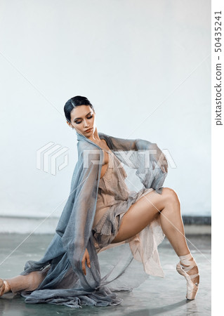 Beautiful young woman dancing in studio in pointe shoes 50435241