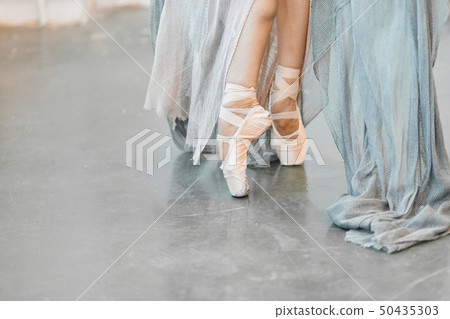 Close up view of elegant ballerina standing on toes in pointes 50435303