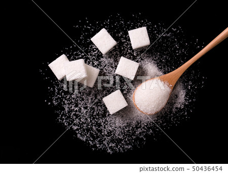 Sugar sand and sugar cubes poured from a wooden Sugar sand and sugar cubes poured from a wooden 50436454