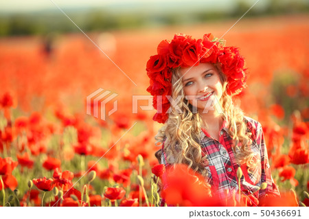 Portrait of a girl on the street with a wreath of poppy flowers on the head Portrait of a girl on the street with a wreath of poppy flowers on the head 50436691