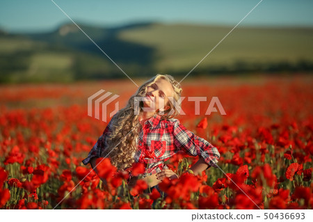 Portrait of a girl on the street with a wreath of poppy flowers on the head Portrait of a girl on the street with a wreath of poppy flowers on the head 50436693